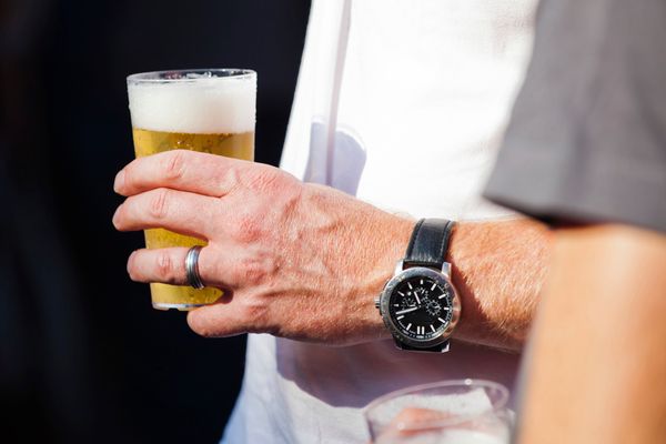 Man with watch and beer