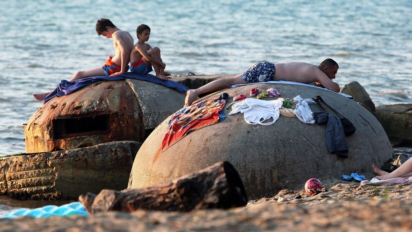 People sunbathe atop decrepit communist-era bunkers o