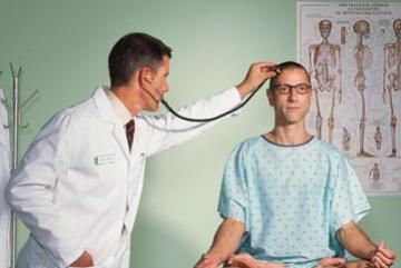 man doing yoga while his doctor checks his heart