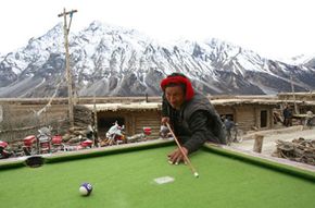 A Tibetan villager plays pool in the outskirts of Basu County of Tibet Autonomous Region, China. The Tibetans are accustomed to the high altitude of their region, though many visitors are afflicted with high altitude sickness.