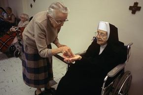 Elderly Sister of Notre Dame receiving her medicine