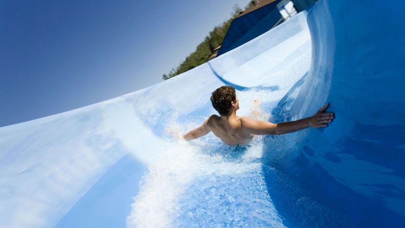 A man goes down a waterslide.