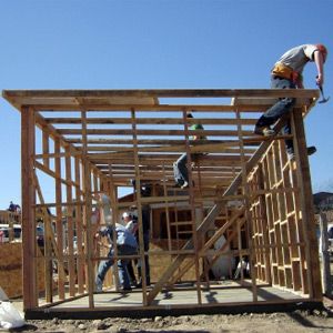 Some average people building a small house.