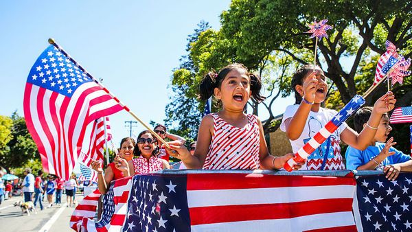 Patriotic smiles on Fourth of July outdoors.