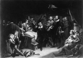 William Bradford, long-time governor of Plymouth Colony (seated) reads the Mayflower Compact.