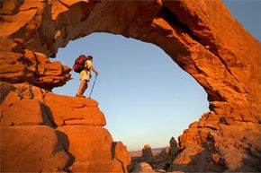 A hiker stands in Arches National Park in Moab, Utah. Heck, a view that breathtaking could inspire anyone to join a hiking society.