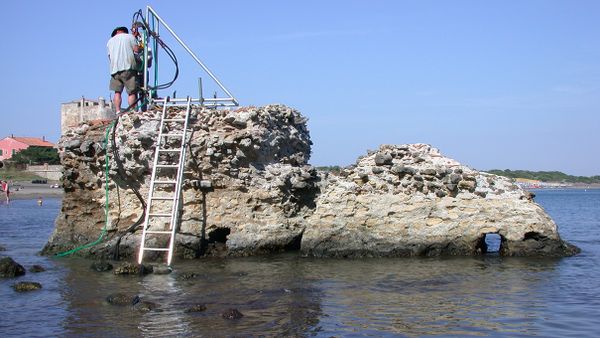 scientists examining ancient roman concrete pier