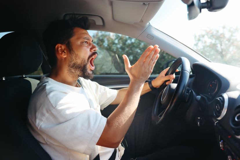 Angry screaming male driver driving car