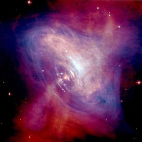 In this composite image of the Crab Nebula, matter and antimatter are propelled nearly to the speed of light by the Crab pulsar. The images came from NASA's Chandra X-ray Observatory and the Hubble Space Telescope.