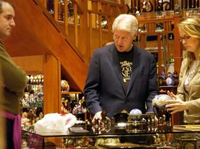 Former U.S. President Bill Clinton adds to his collection in an antique shop in downtown Prague 11 November 2005.