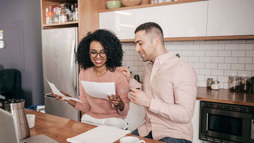 couple in kitchen looking at papers