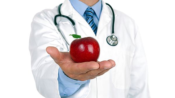 Men doctor providing healthcare and medicine with stethoscope and fruit.