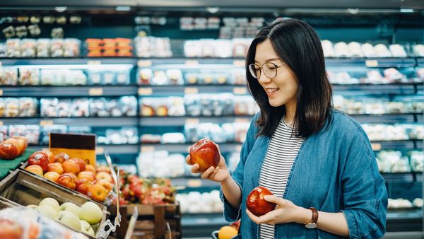 asian woman picking apples