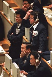 Traders react to a sell-off on the Tokyo Stock Exchange. Shares plunged partly because of arbitrage selling.