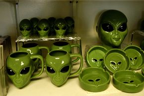 Alien theme mugs and bowls on a shelf in a gift shop