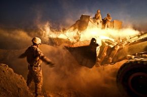 Combat engineers from the Marines tear down patrol bases throughout Helmand province in Afghanistan in December 2011, paving the way for Afghan pullout by U.S. troops.