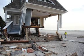 美国陆军工程兵团的一名残骸工程师正在检查被飓风桑迪摧毁的房屋，纽约皇后区＂width=