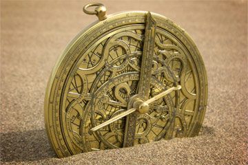 Antique navigational compass guiding directionless sundial.