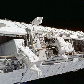 Astronauts install a truss, which was delivered to the space station by Endeavour (STS113).