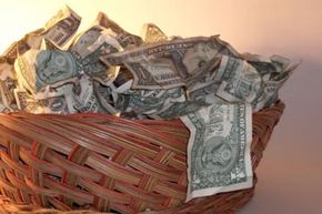 A donation basket filled with dollar bills.
