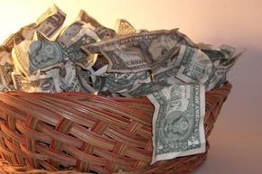 一个donation basket filled with dollar bills.