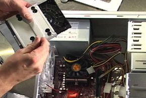 Placing the hard drive into its bracket.