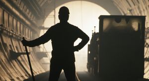 Men silhouetted outdoors, one person.