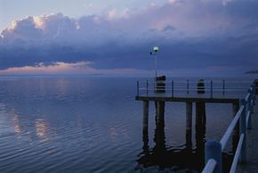 A pier overlooks&nbsp;a body of water just before nightfall.