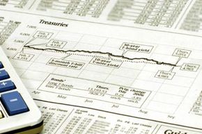 The treasuries section of a financial newspaper, with a calculator.