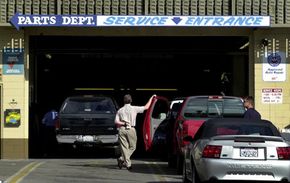 An auto garage with a lone ling of cars waiting to be serviced.&nbsp;