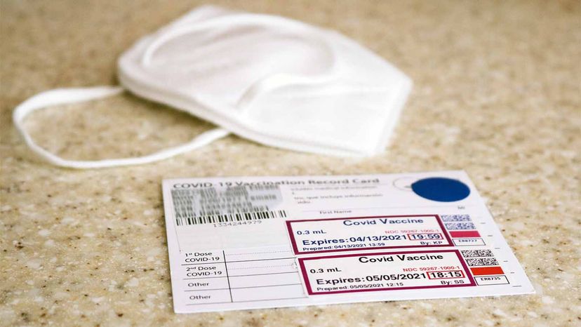 vaccine card and N95 mask