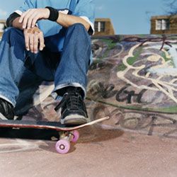 Roller blader female grinding on a ledge in a skatepark. Cool