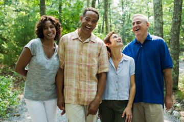 two baby boomer couples smiling for the camera