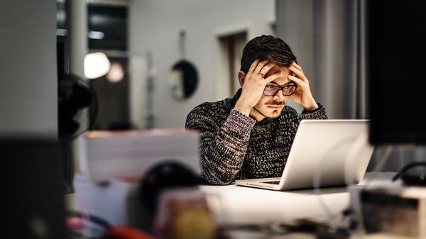 businessman working frustrated at laptop