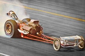 Pete Robinson, pictured here driving a dragster, got a leg up on his competitors by using folding jack stands to raise the rear of his car.