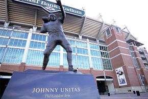 A statue of Hall of Fame quarterback Johnny Unitas sits outside the Baltimore Ravens' Stadium in Baltimore, Md. Fans touch it for luck