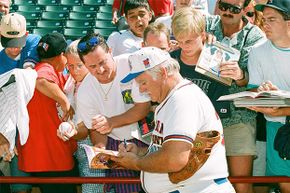 Gaylord Perry signs autographs during the 1995 All Star Weekend in Arlington, Texas.