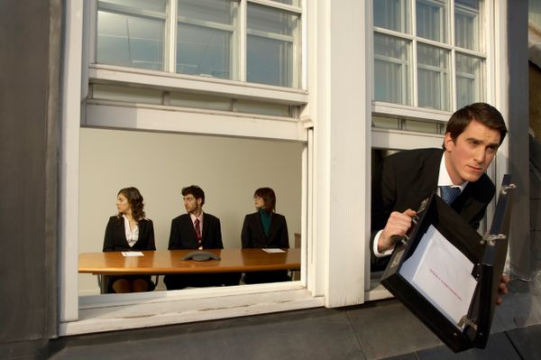 man hiding paperwork