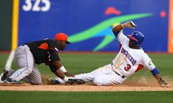 Willy Taveras of The Dominican Republic is tagged out trying to steal third base by Yurendell DeCaster of The Netherlands during the 2009 World Baseball Classic.