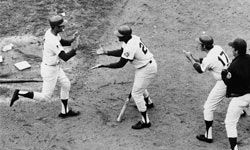 New York Mets outfielders Tommie Agee (center) and Rod Gaspar (right) greet second baseman Al Weis after Weis tied the score in the fifth game of the 1969 World Series.