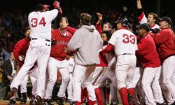 Boston Red Sox players celebrate after David Ortiz hit the game winning two-run home run in the 12th inning against the Yankees in game four of the 2004 American League Championship Series. See more sports pictures.