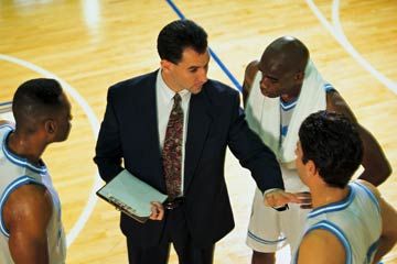 A coach speaks to basketball players.