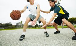 Tow young men playing basketball