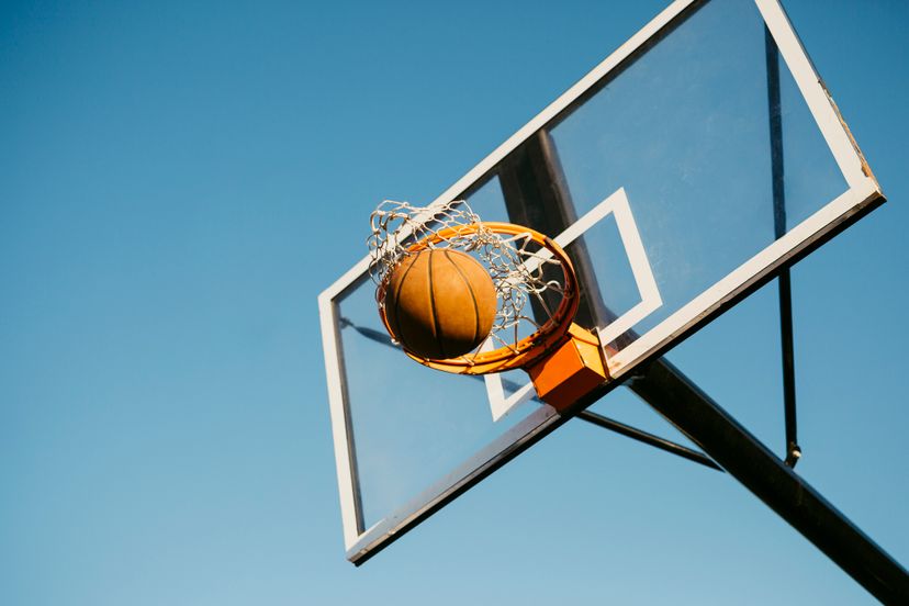 Basketball ball getting in to the basket during a game on the street