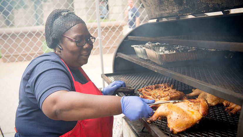 Mary Simon owner of Mama Mary's BBQ prepares chicken for judges at the National Capital Barbecue Battle in 2014. Her grill allows her to do direct and indirect grilling. Marvin Joseph/The Washington Post via Getty Images