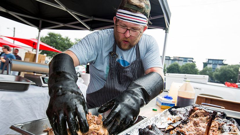 North Carolina Barbecue: Wyatt Dixon prepares pulled pork by extracting it from the smoked pig and adding his Pig Whistle sauce. April Greer For The Washington Post via Getty Images