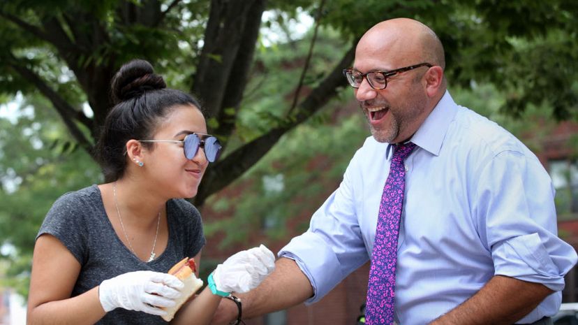 Representative Jeffrey Sánchez, chairman of the House Committee on Ways and Means, jokes with Ghiana Guzman during a cookout at the Mildred C. Hailey Apartments in the Jamaica Plain neighborhood of Boston in 2017. Craig F. Walker/The Boston Globe via Getty Images