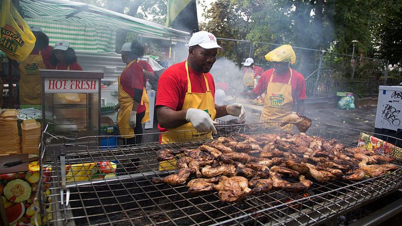 Cooks make Jamaican-style jerk chicken at the Notting Hill Carnival in London. Mike Kemp/In Pictures via Getty Images