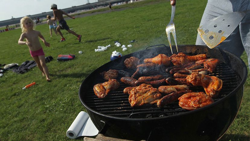 A family prepares barbecued chicken and sausages at the former Tempelhof airport in Berlin, Germany. Sean Gallup/Getty Images