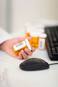 pharmacist scanning bar code on pill bottle